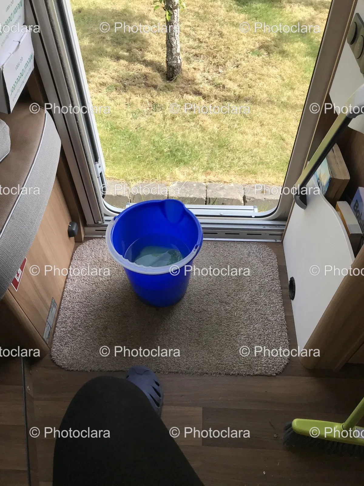 Blue-Bucket-by-the-Door-on-a-Rug.jpg