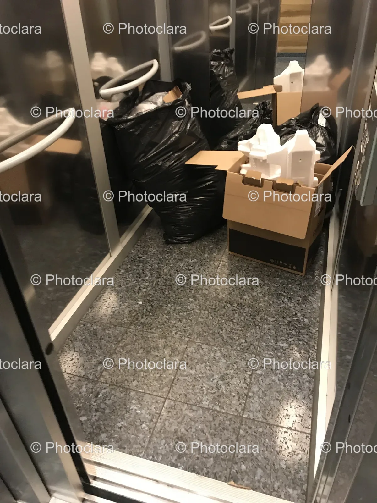 Black-Bags-and-Cardboard-Box-in-Room.jpg