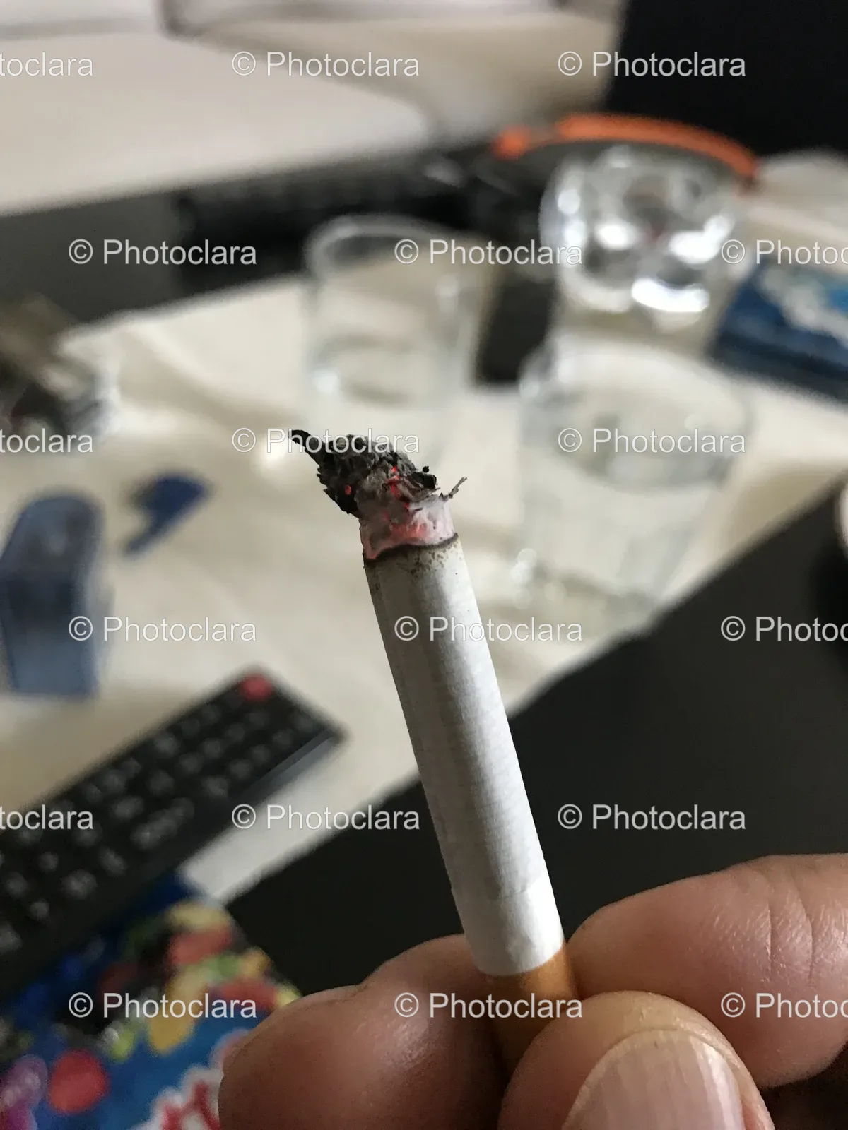 hand-holding-cigarette-indoors.jpg