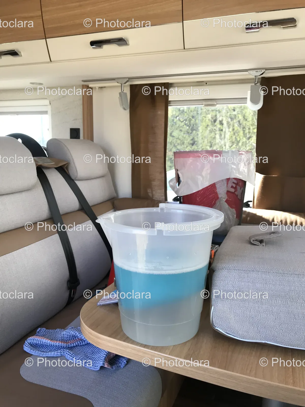 bucket-of-blue-liquid-in-vehicle.jpg