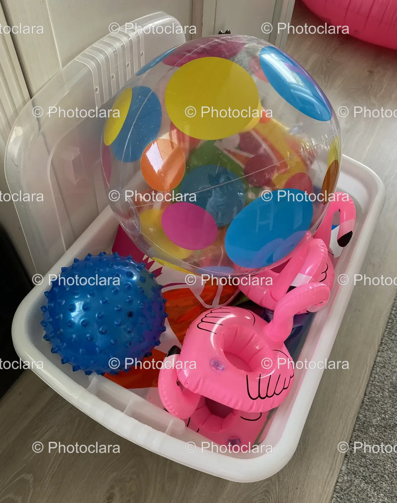 plastic-and-pink-balls-in-white-container.jpg