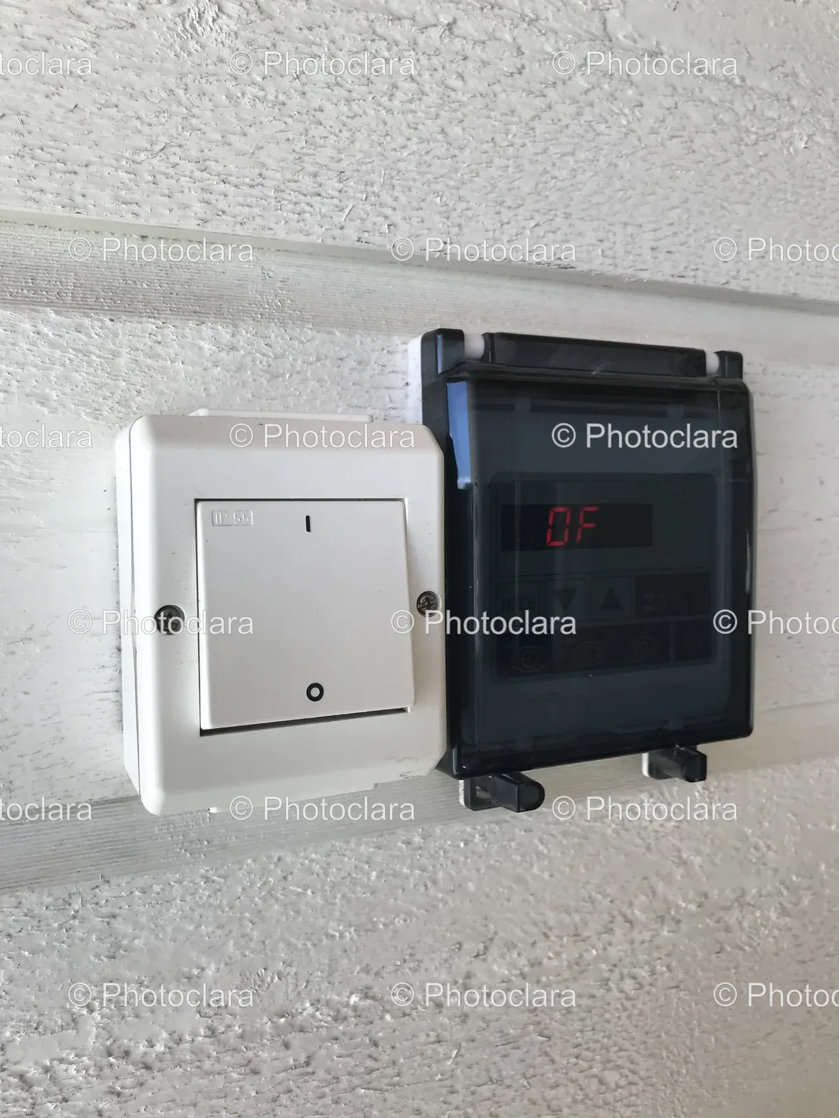black-device-and-white-switch-on-white-wall.jpg