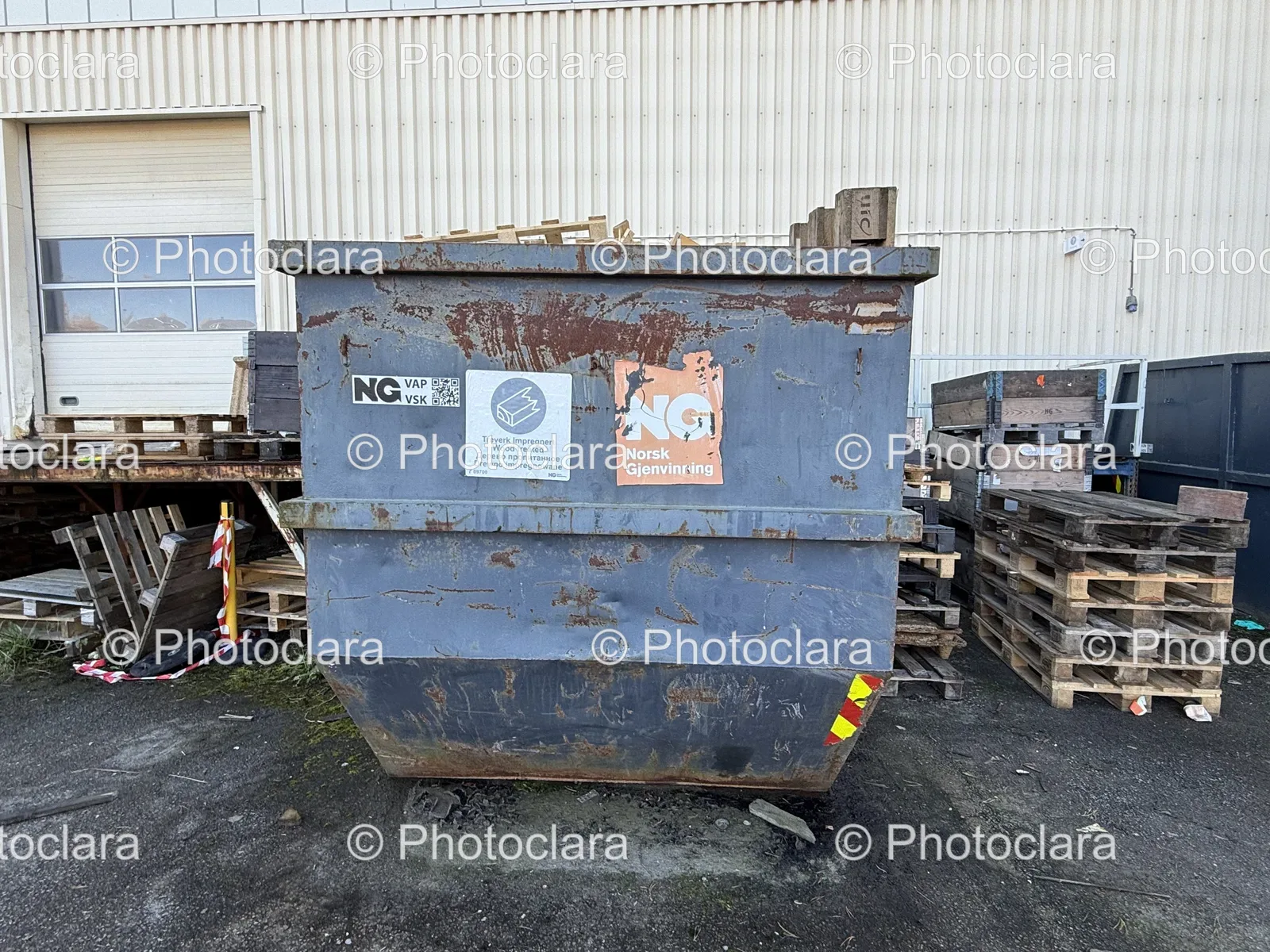 Large-Metal-Container-with-Pile-of-Pallets.jpg