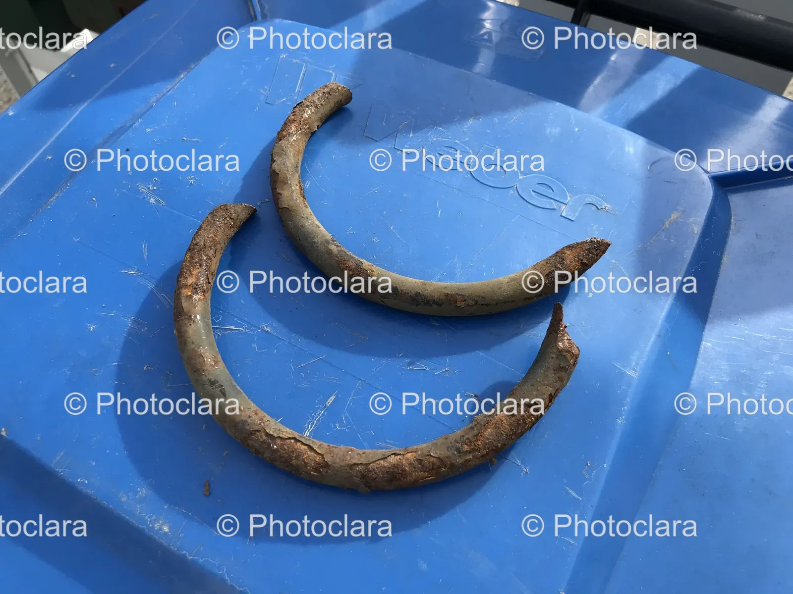 Rusty-Metal-Object-on-Blue-Plastic-Container.jpg