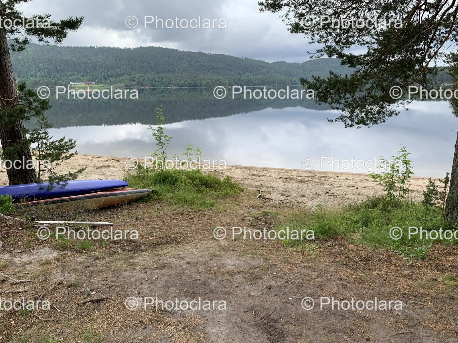 Canoe-on-Lake-Shore-with-Mountain-View.jpg
