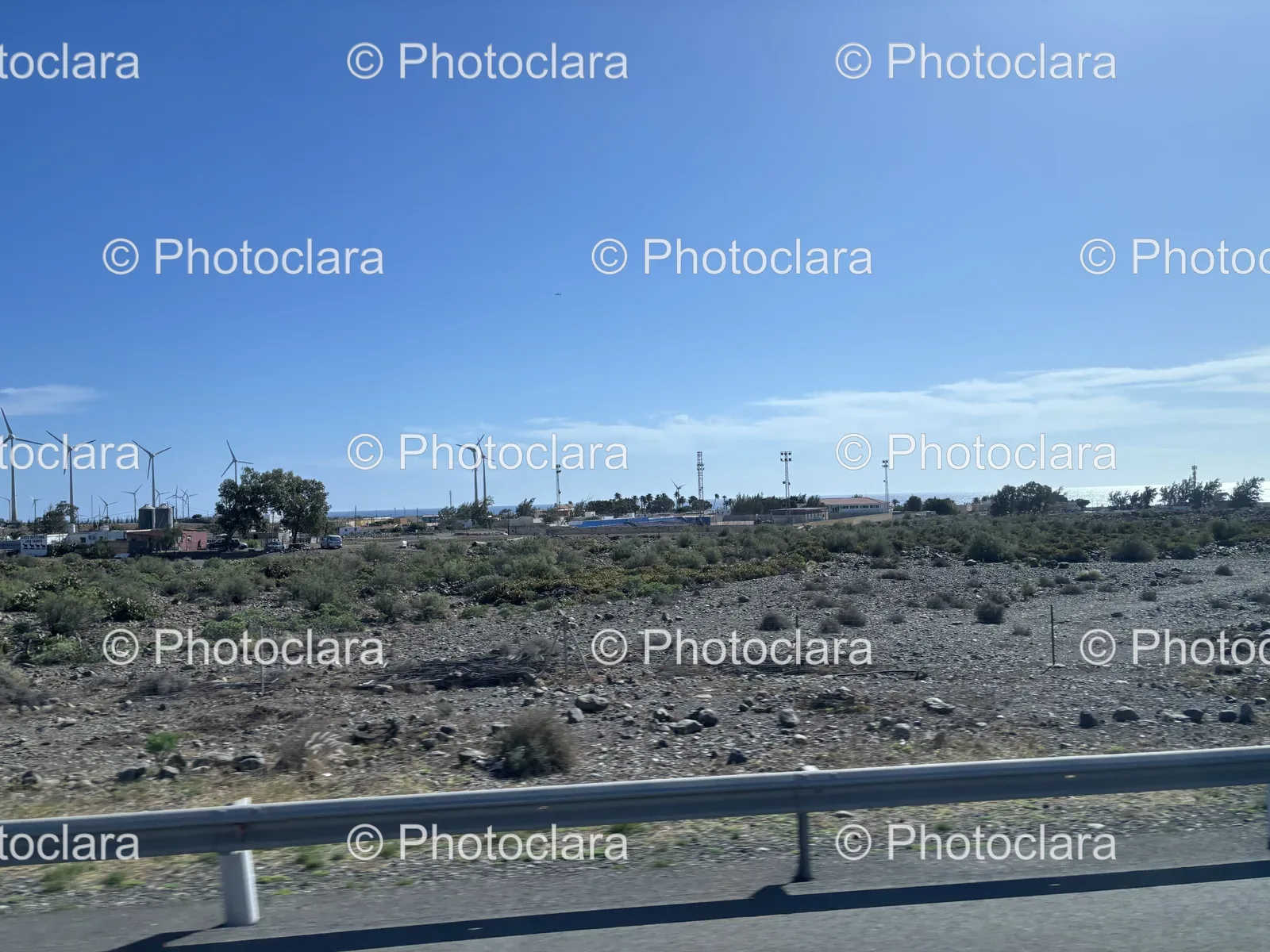 Scenic-Road-with-Rocky-Terrain-and-Water-View.jpg