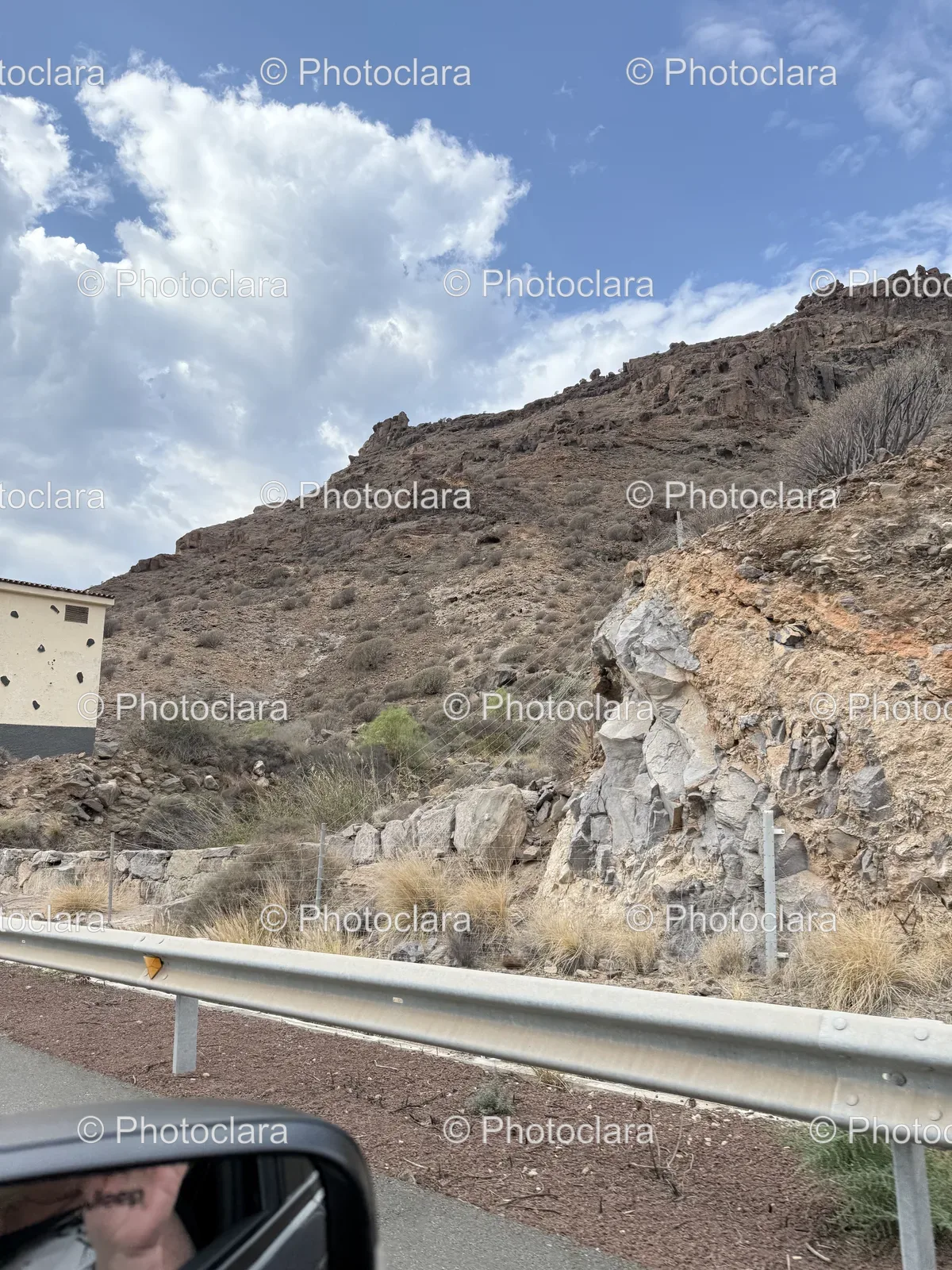 Serene-Road-Through-Hills-With-Building.jpg