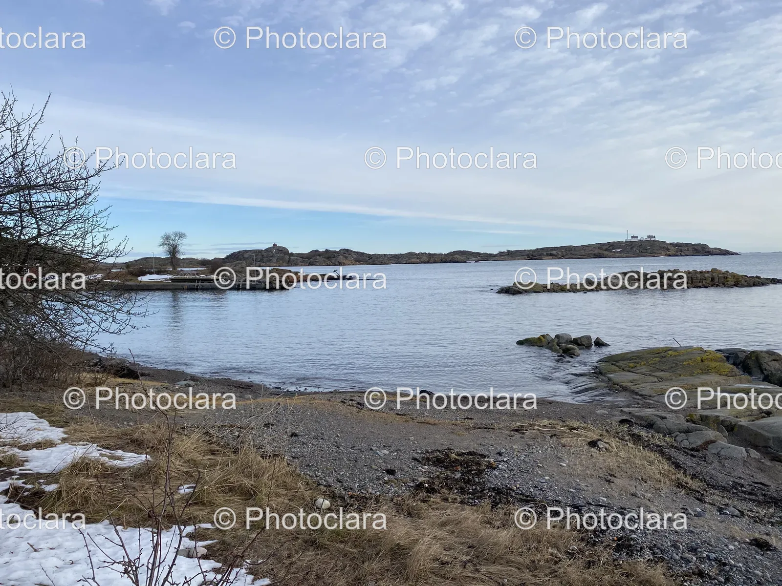 serene-rocky-shore-with-snow-and-lake.jpg