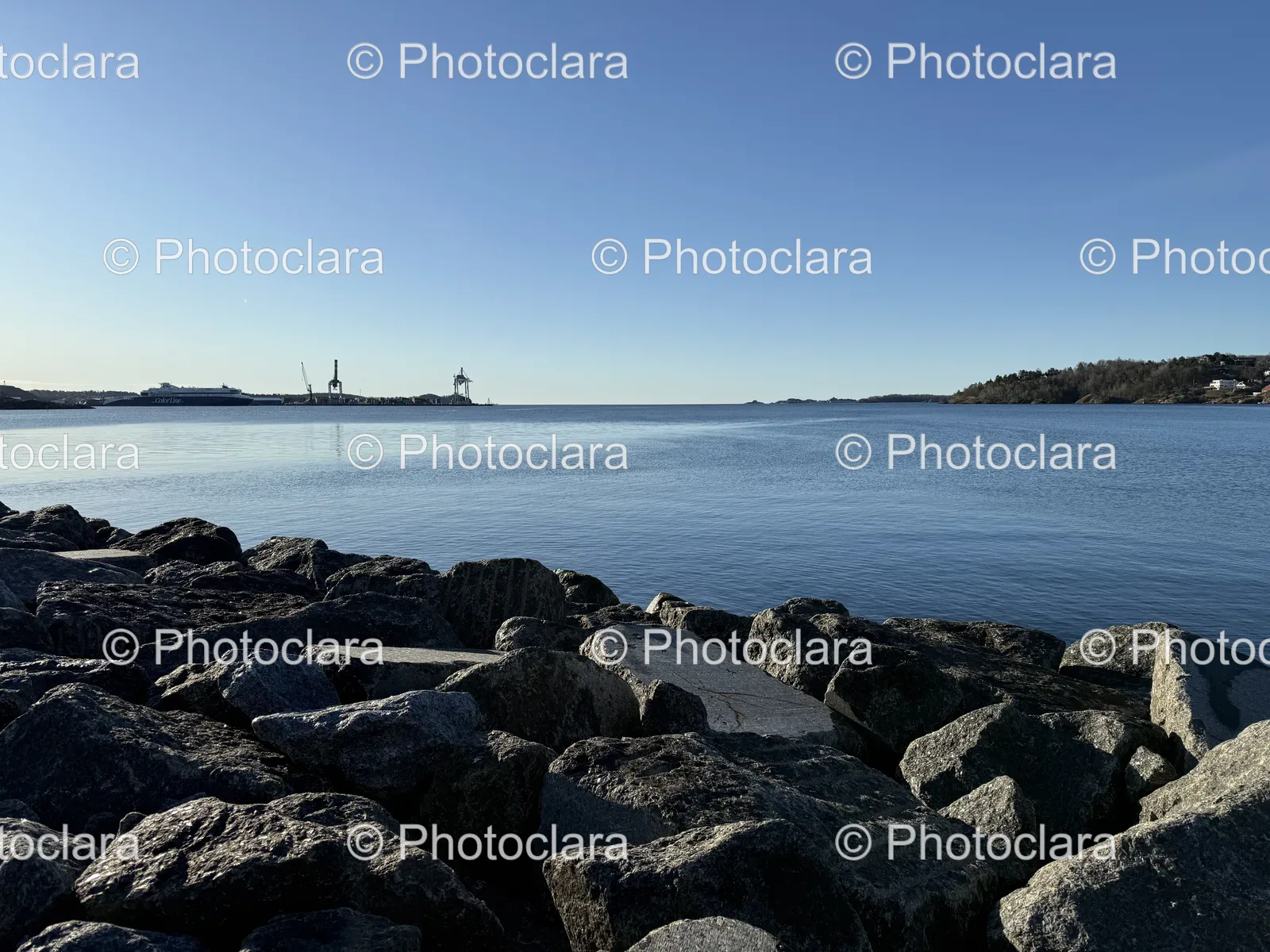Tranquil-Rocky-Shore-with-Distant-Boat.jpg
