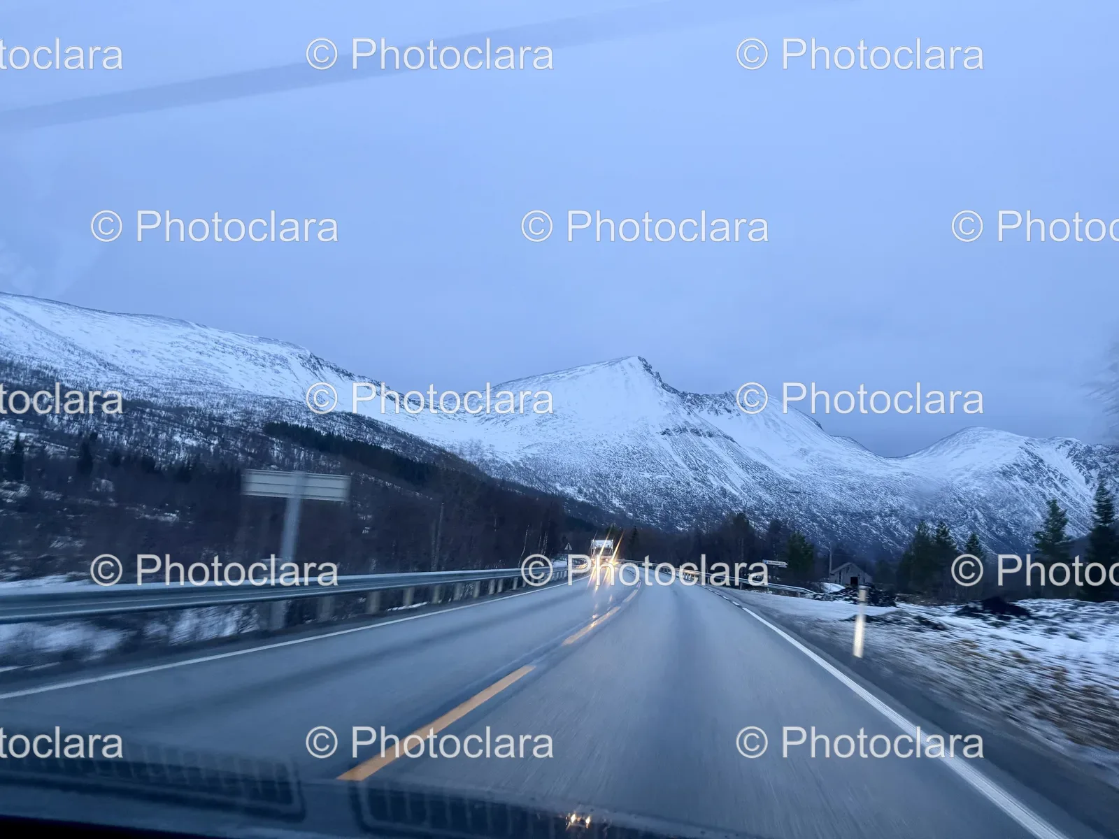 snow-covered-road-mountainous-backdrop.jpg