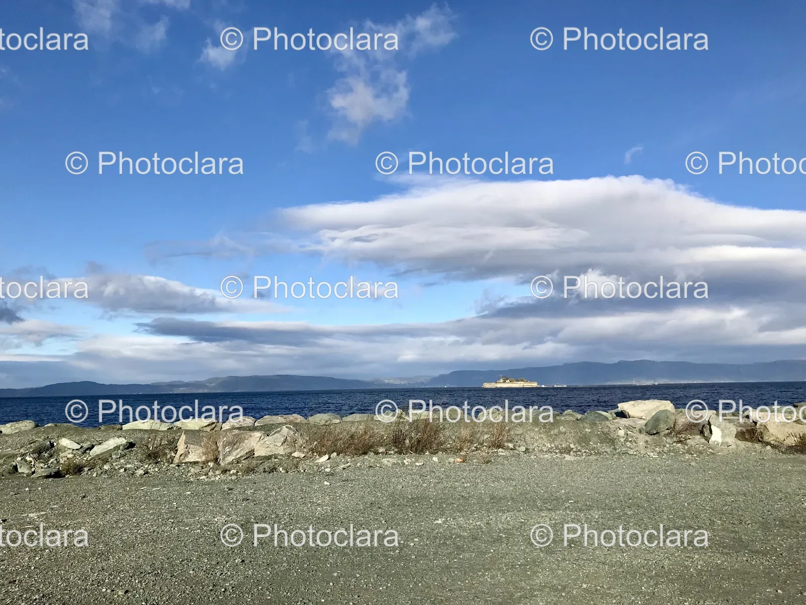 rocky-beach-with-water-and-clouds.jpg