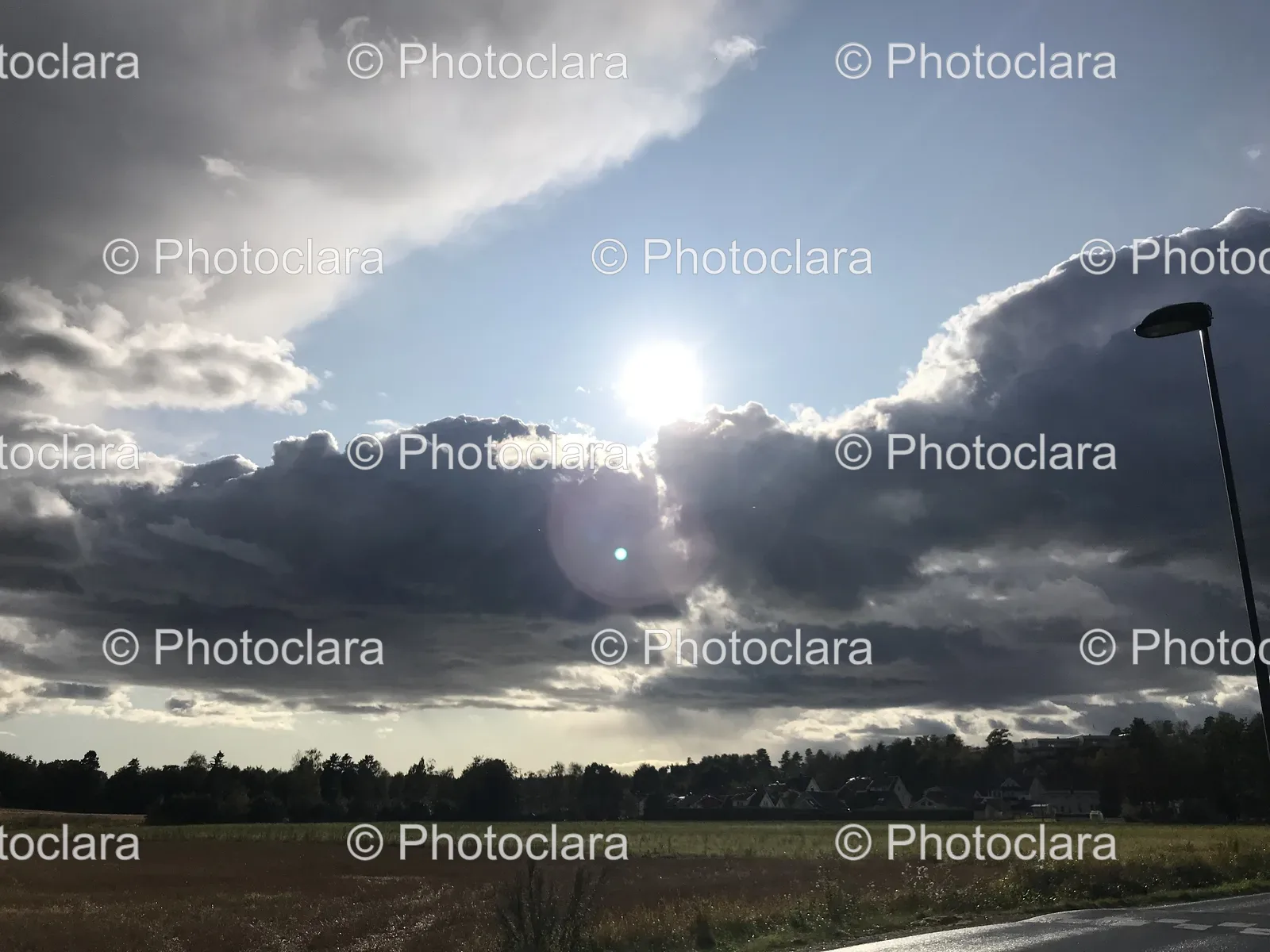 sun-shining-through-clouds-over-a-field.jpg