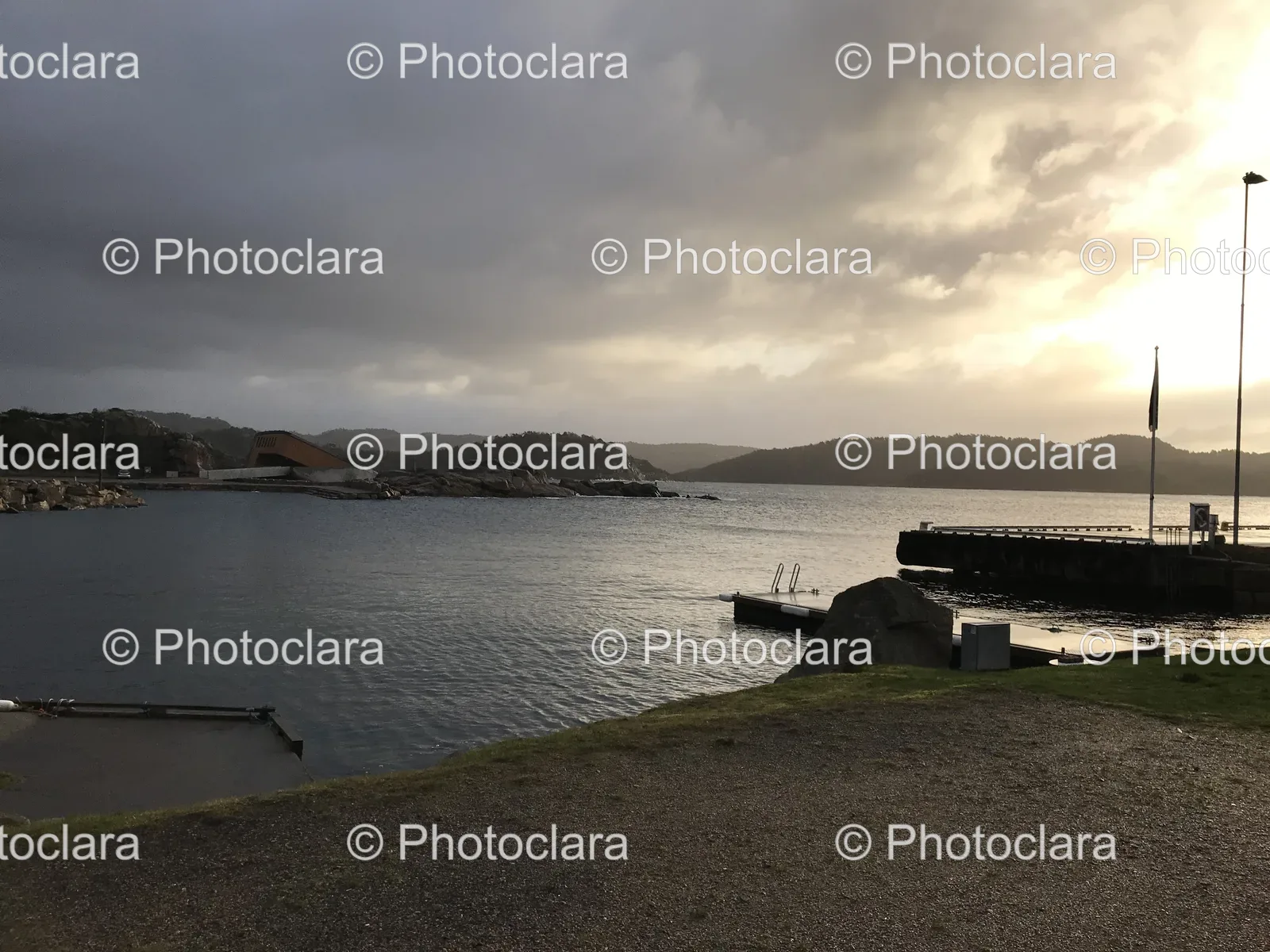 Scenic-Lakeside-with-Dock-and-Buildings-at-a-Distance.jpg