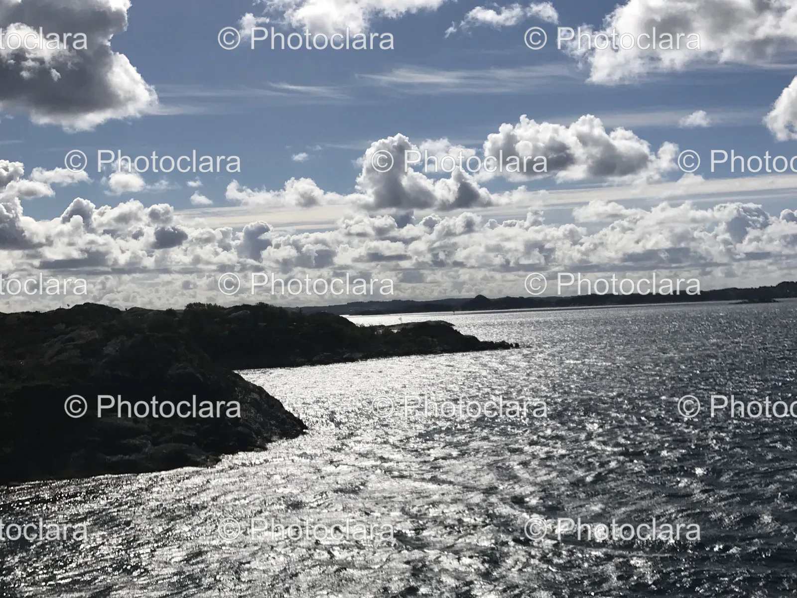 serene-waterbody-with-rocks-and-clouded-sky.jpg