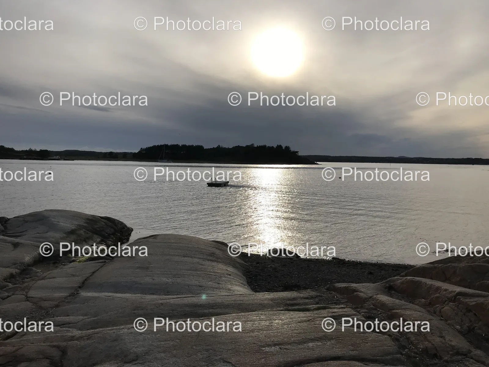 Tranquil-Lakeside-Scene-with-Boat-and-Rocks.jpg