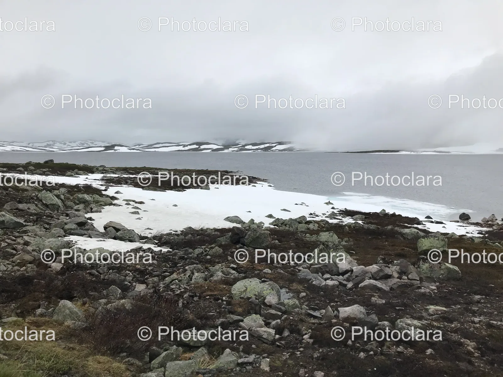 Rocky-Shore-Snow-Mountain-Background.jpg