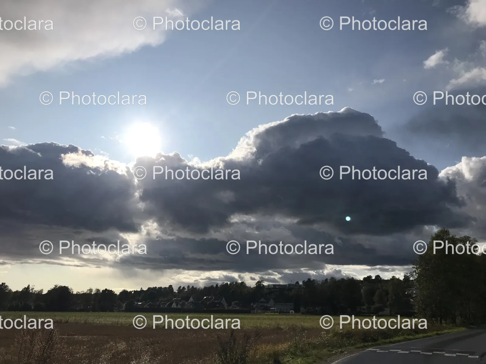 Sun-Shining-Through-Clouds-Over-a-Field.jpg