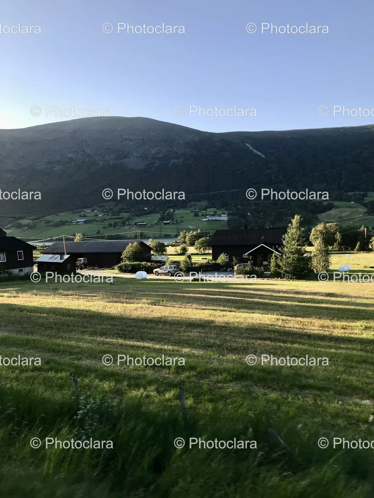 serene-field-buildings-mountains.jpg