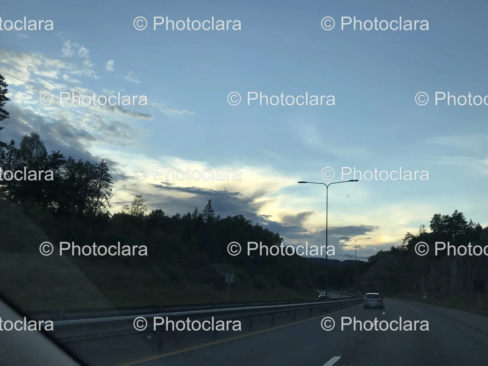 A-Road-with-Trees-under-a-Cloudy-Sky.jpg