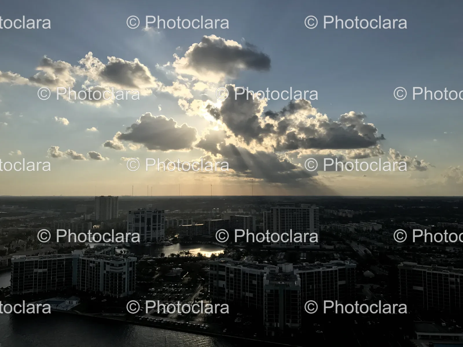 sun-shining-through-clouds-over-a-city.jpg