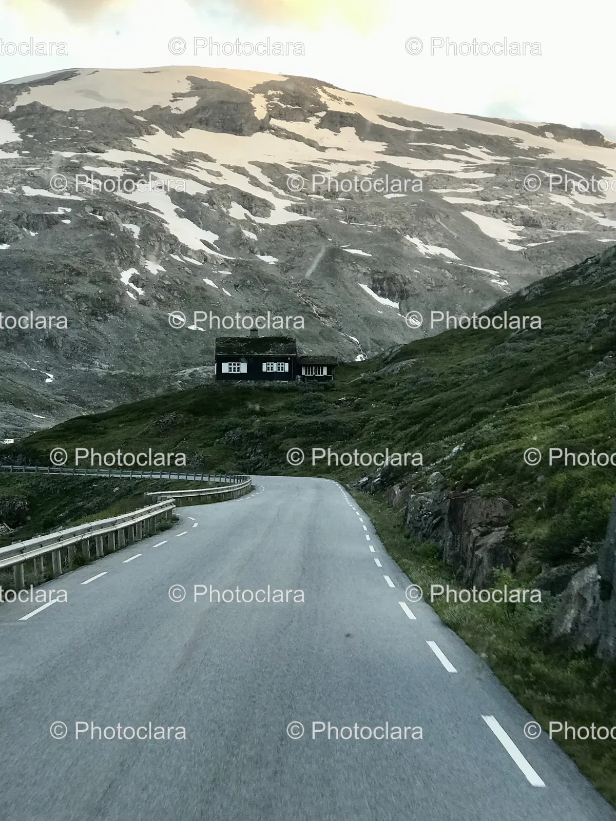 Snowy-Mountain-Road-Leading-to-a-Cozy-House.jpg