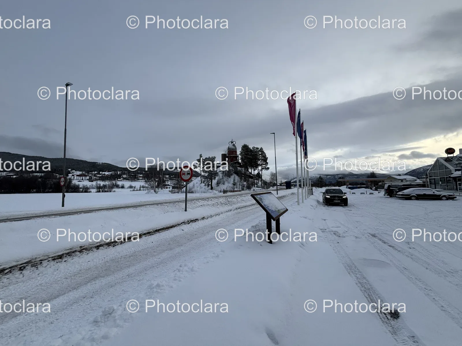 Snowy-Road-with-Flags-and-Sign.jpg