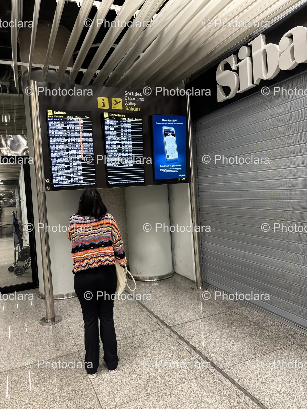 Person-Standing-in-Front-of-Departure-Sign.jpg