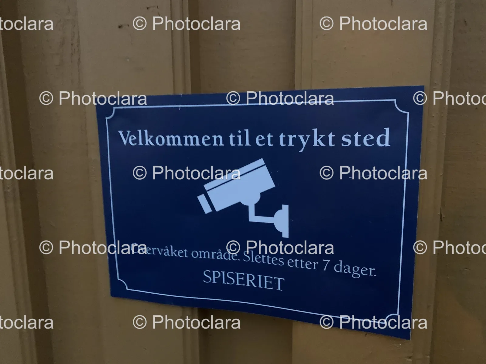 Welcoming-Blue-Sign-on-Brown-Wall.jpg