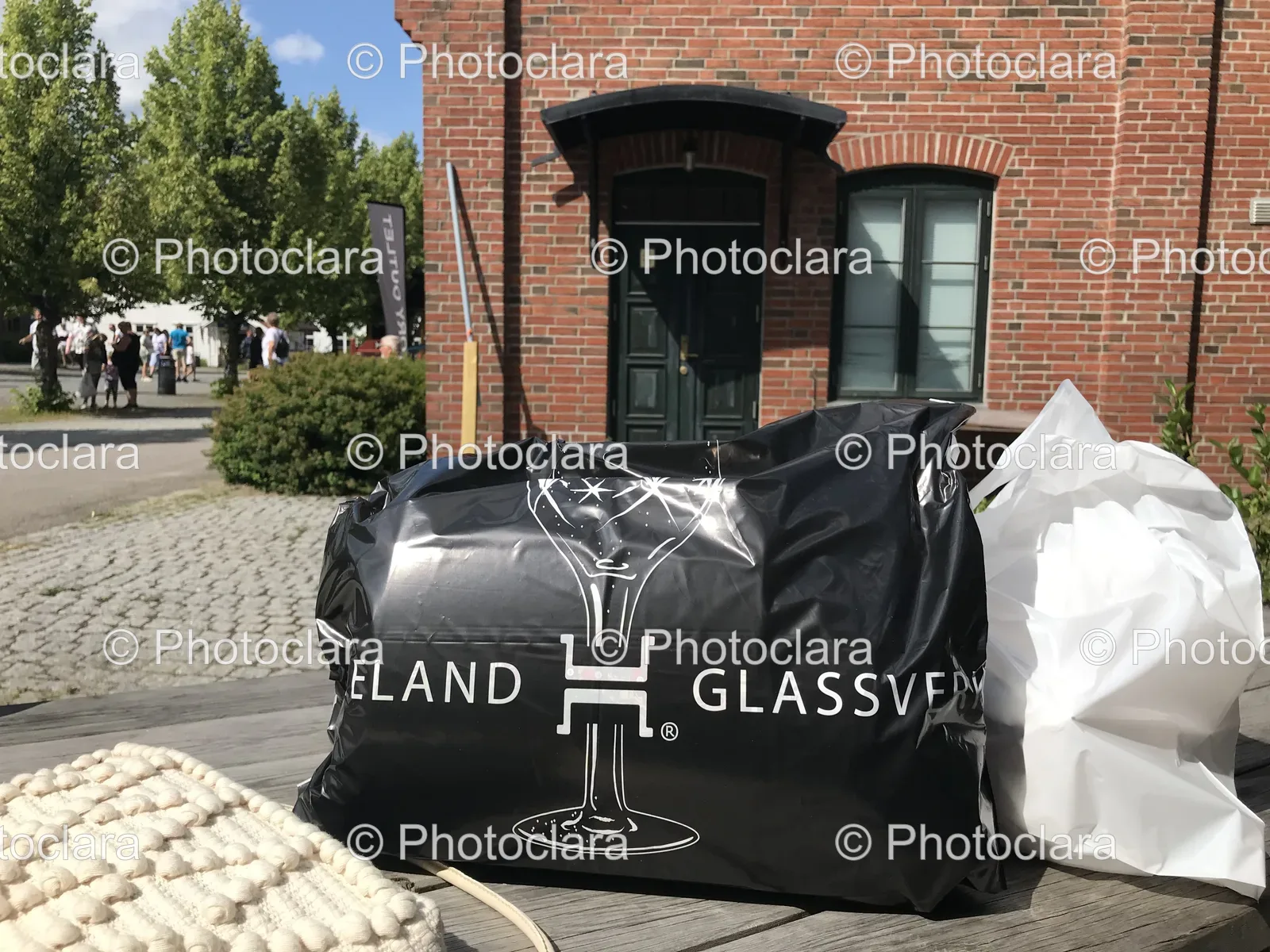 Black-Plastic-Bag-with-White-Text-Outside-Brick-Building.jpg