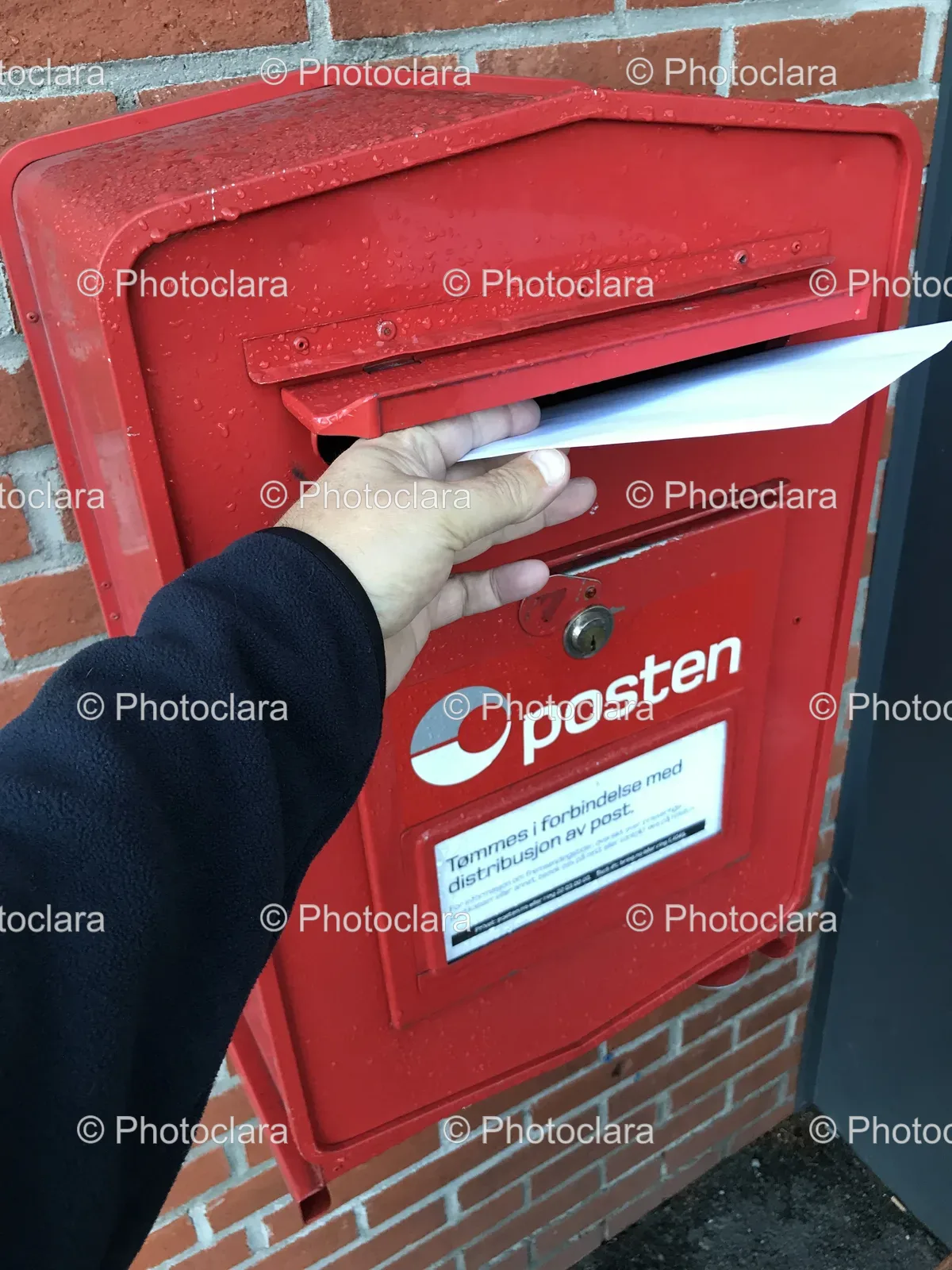 Hand-Placing-Letter-Into-Red-Mailbox.jpg