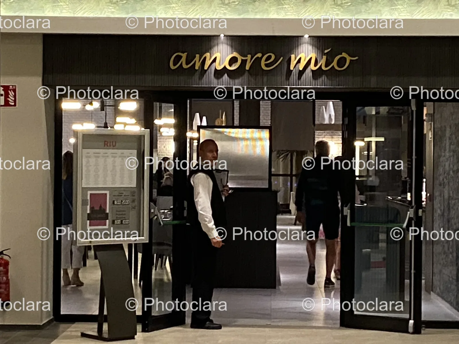 Person-Standing-Glass-Door-Amore-Mio-RIU.jpg