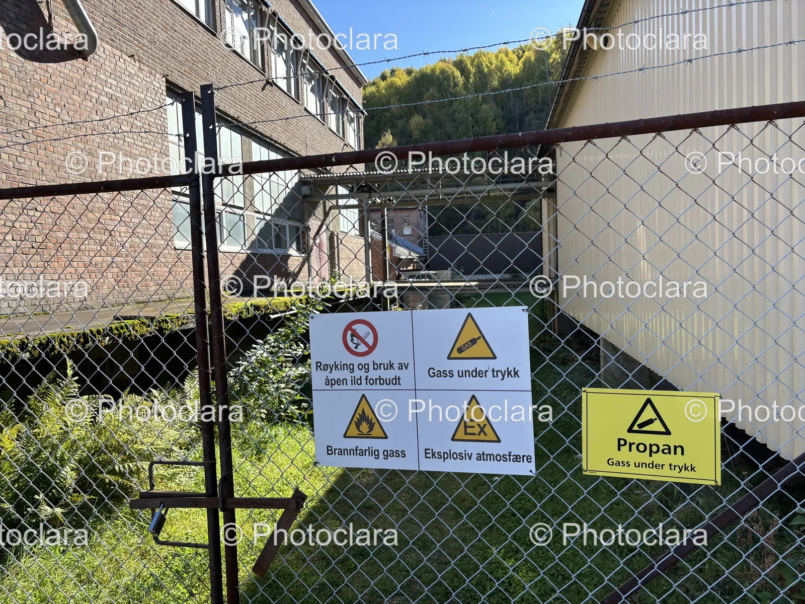 Signs-on-a-Fence-with-Building-Behind.jpg