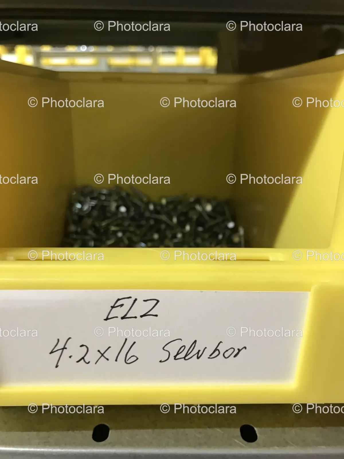 yellow-bin-with-white-label-containing-screws.jpg