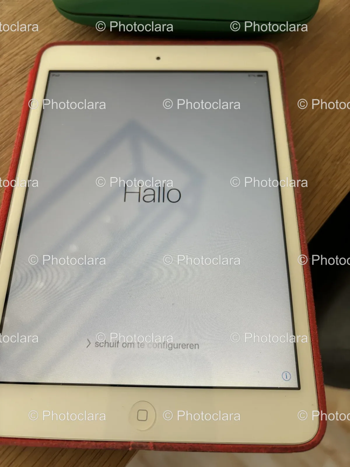 White-Tablet-with-Red-Cover-on-Wood-Surface.jpg