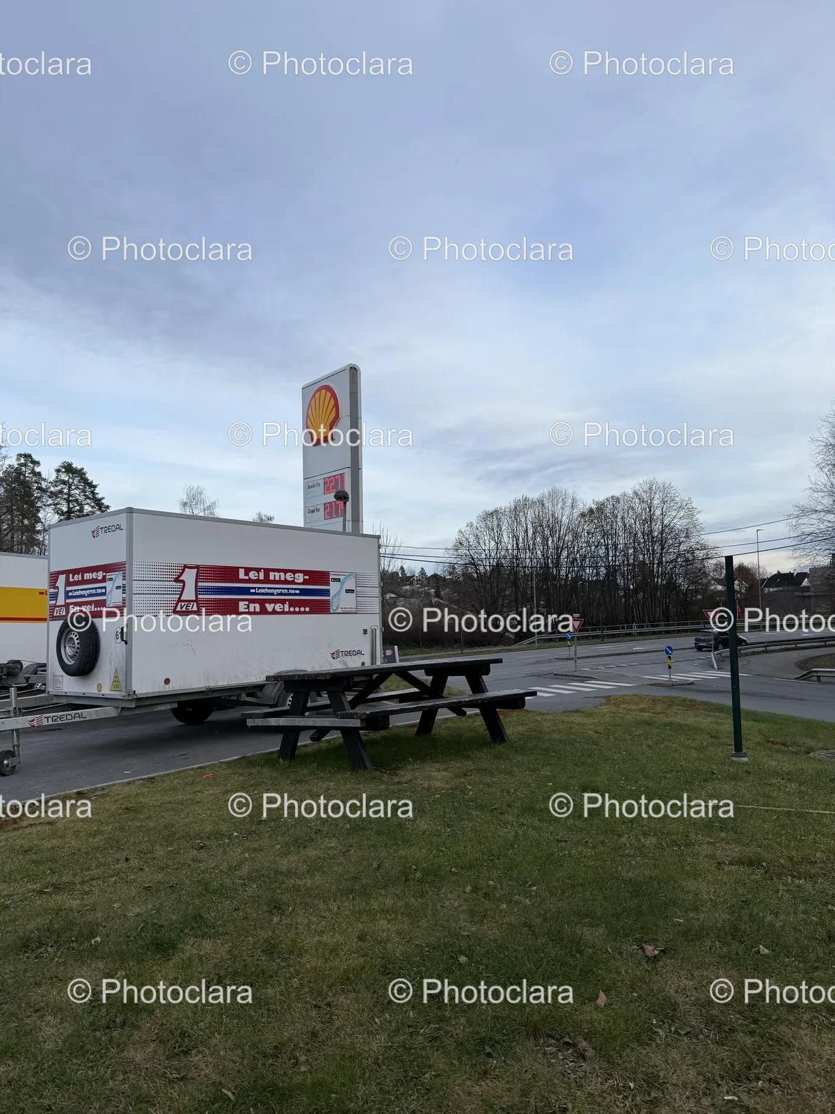 White-Trailer-with-Red-and-White-Logo-in-Scenic-Field.jpg