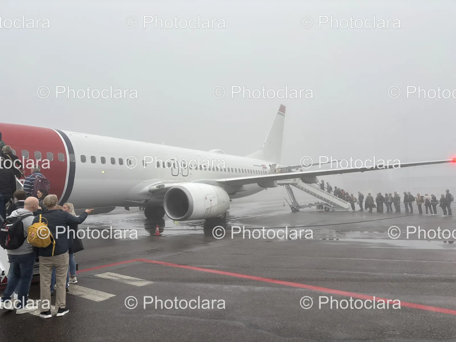 People-Standing-Next-to-Norwegian-Plane.jpg