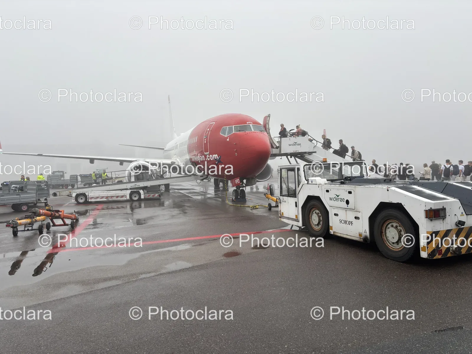Plane-Being-Towed-by-Tow-Truck-Wideroe-Norwegian-Airport.jpg