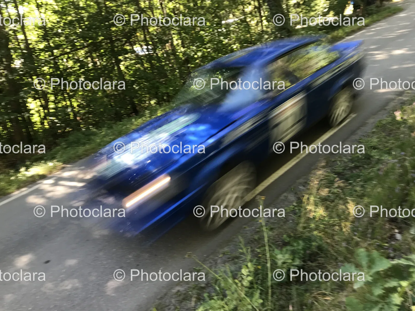 blue-car-driving-on-scenic-road.jpg