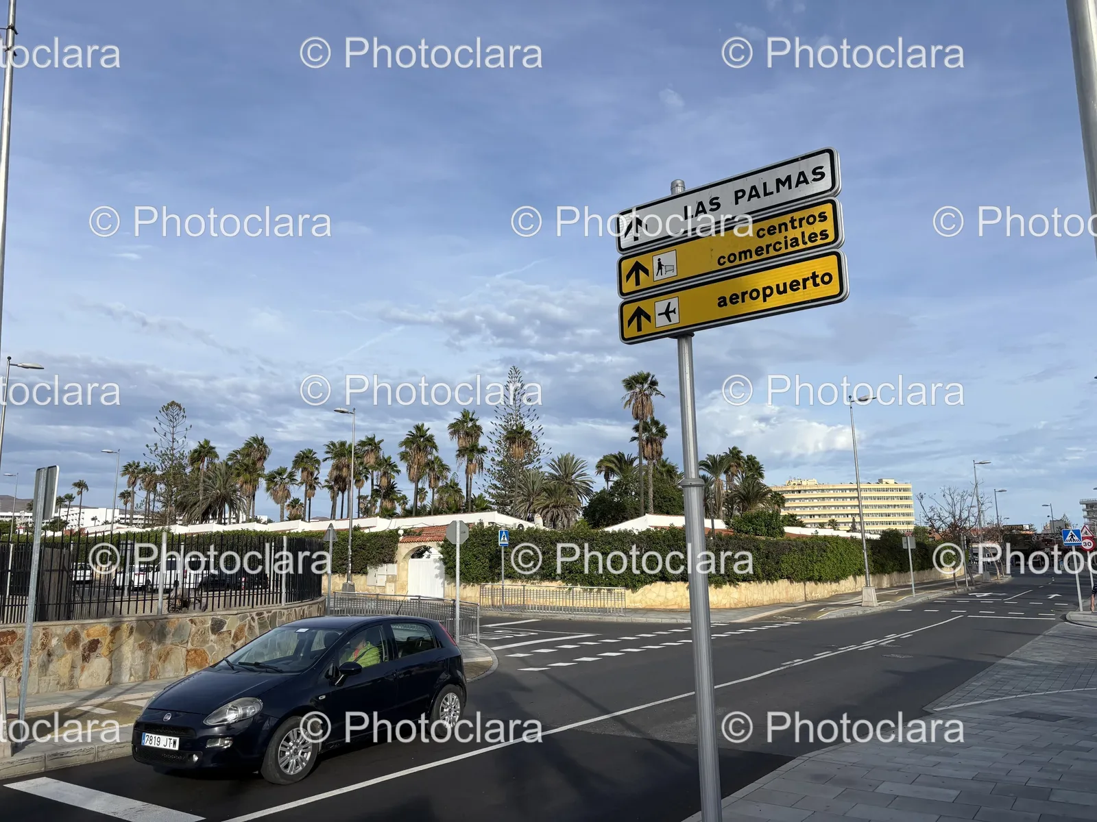 Black-Car-Parked-on-City-Street-Next-to-Signage.jpg