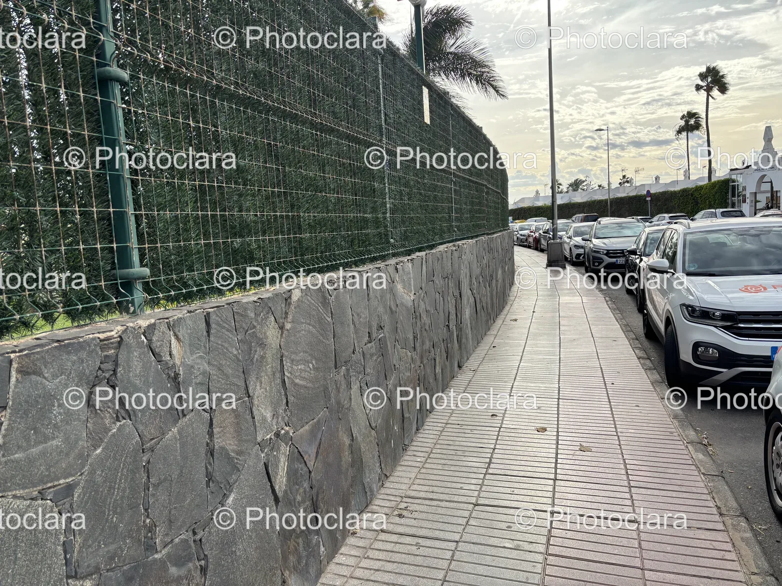 sidewalk-scene-with-parked-cars-and-fence.jpg