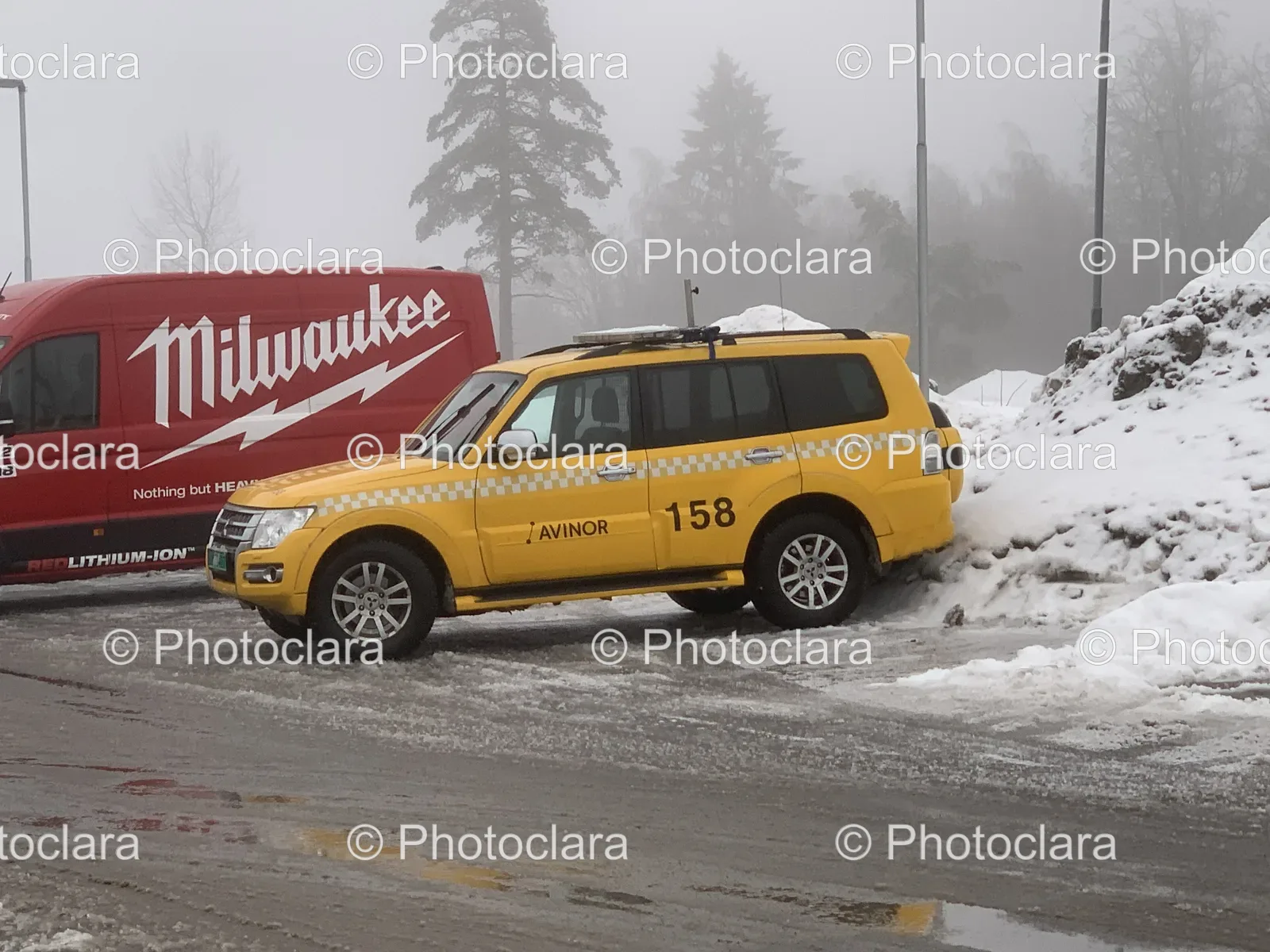 Yellow-Car-Parked-on-Snowy-Road.jpg