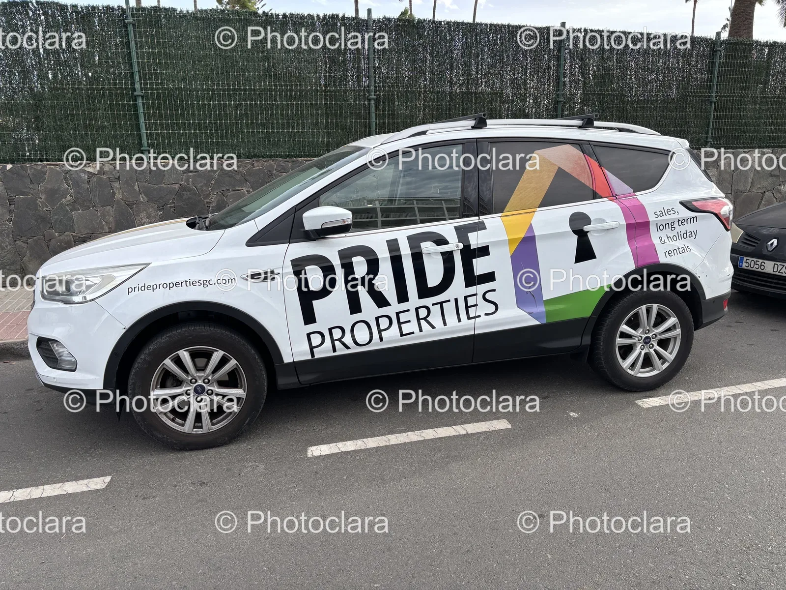 car-parked-in-lot-with-property-advertisement.jpg