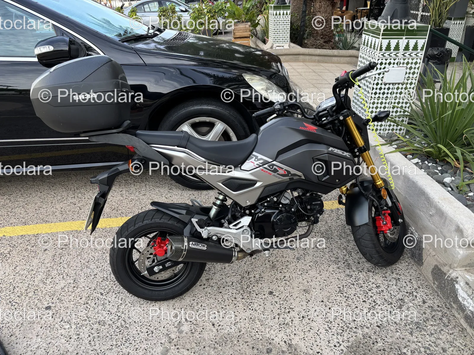 Honda-Motorcycle-Parked-Next-To-Car.jpg