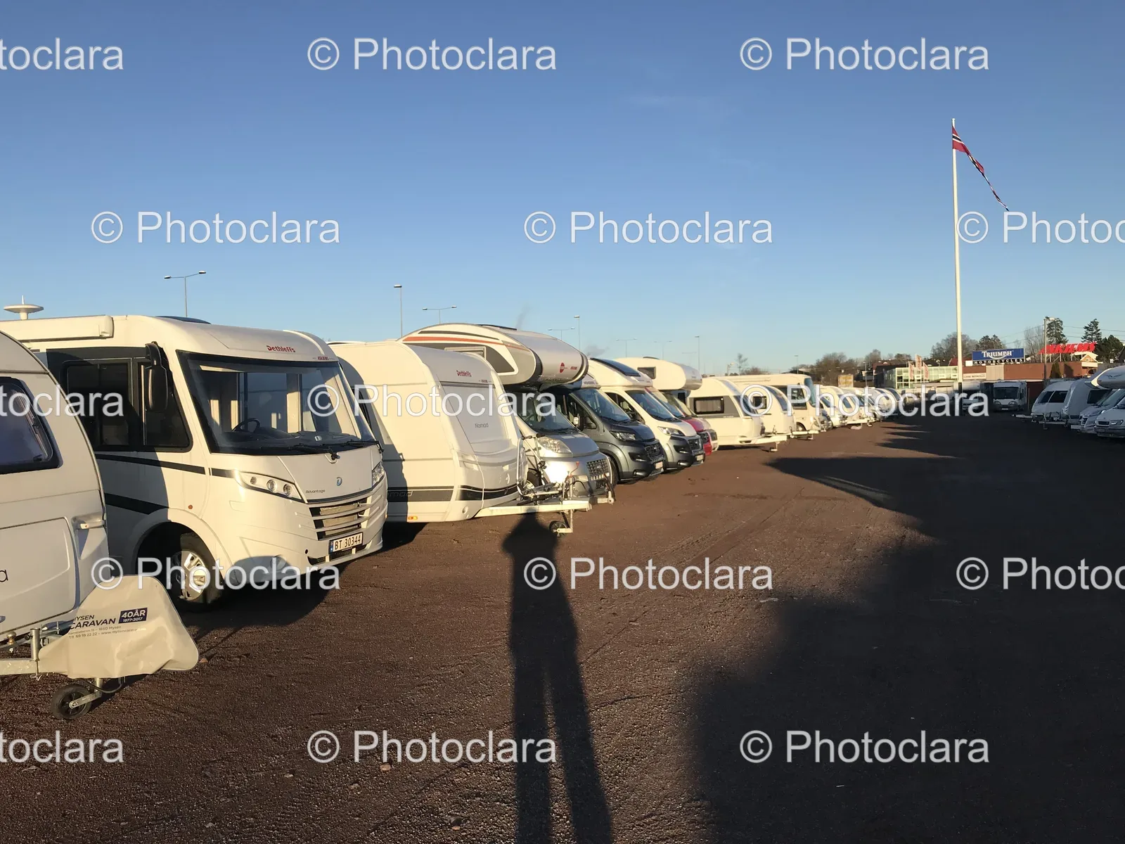 Group-of-White-Vans-Parked-in-a-Parking-Lot.jpg