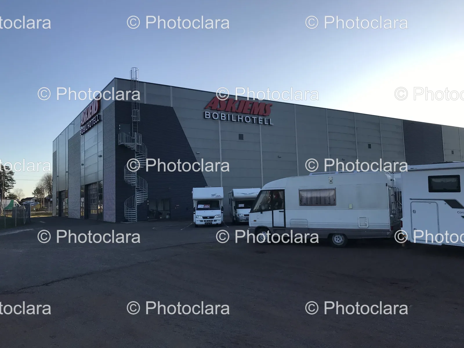 Group-of-White-Vans-Parked-Outside-a-Building.jpg