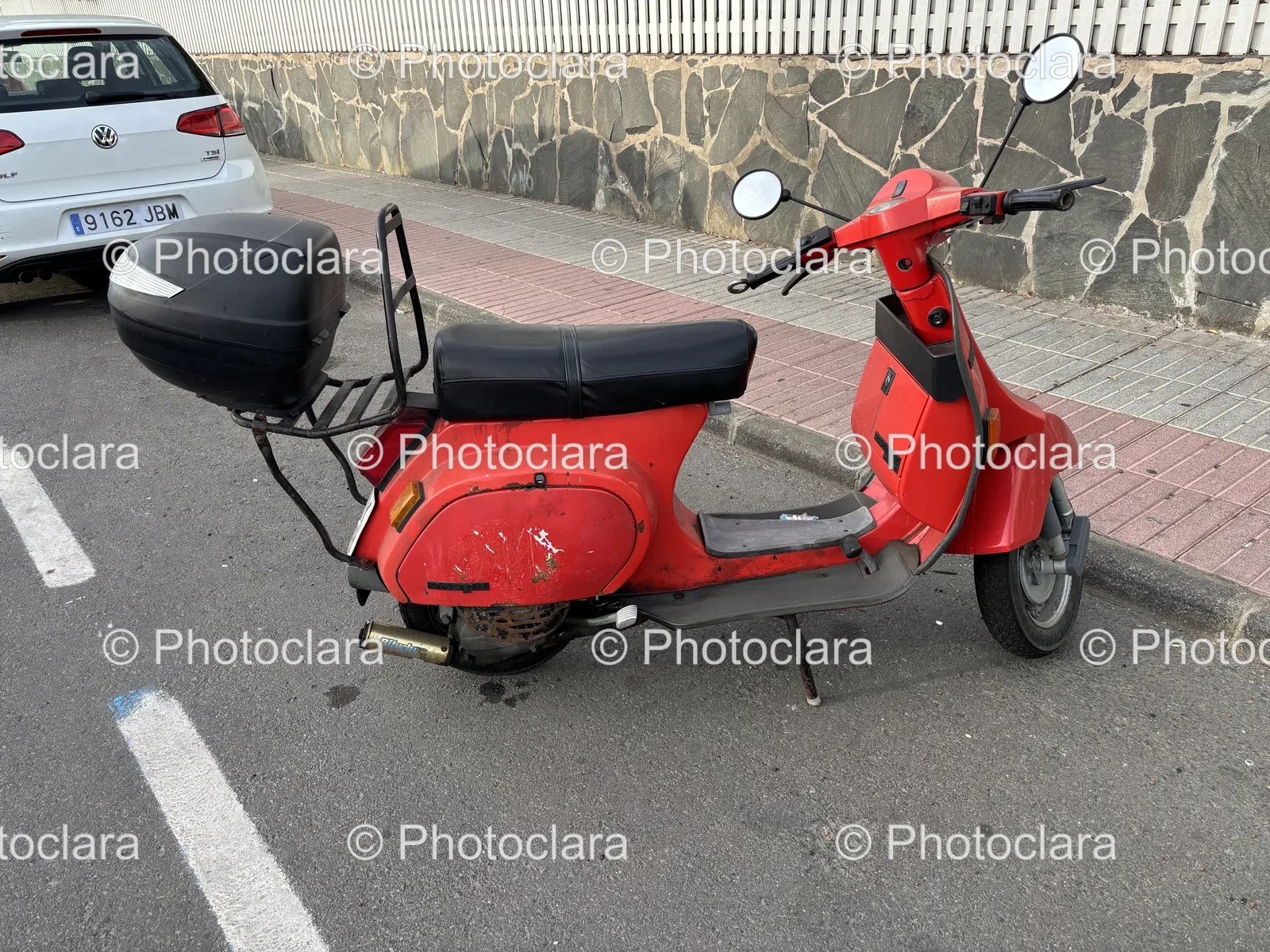 Red-Scooter-Parked-City-Sidewalk.jpg