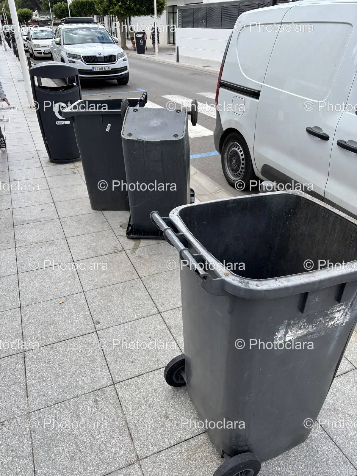 Trash-Cans-Aligned-on-Urban-Sidewalk.jpg
